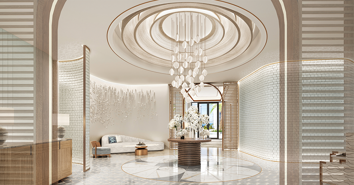 Elegant lobby with sculptural chandelier and curved architectural walls.