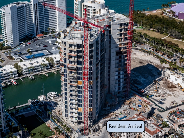 Waterfront condominium tower under construction with resident arrival area.
