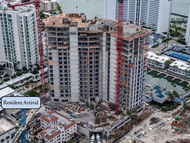 South side of waterfront residential tower under construction with cranes.