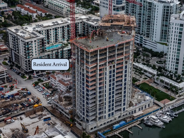 Upper floors of waterfront high-rise during rooftop slab construction.