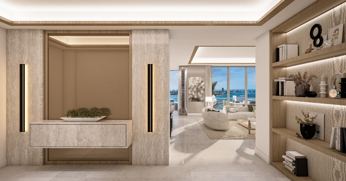 Luxury foyer with stone console, illuminated shelving, and view to a bright living room and water beyond.