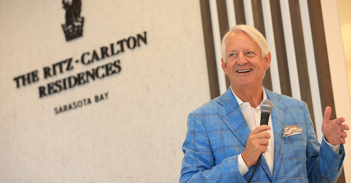 Man speaking at Ritz-Carlton Residences Sarasota Bay presentation gallery event.